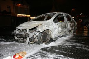 The shell of a torched car after rioting on Friday night at Carnmoney Road, Glengormley. © Pacemaker