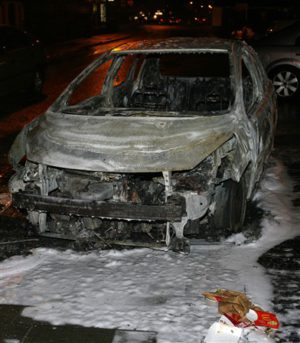 The shell of a torched car after rioting on Friday night at Carnmoney Road, Glengormley. © Pacemaker