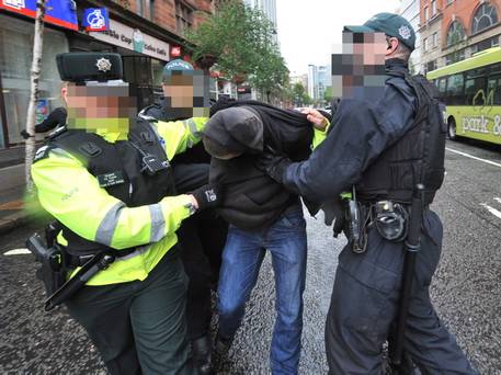 RNU peaceful protester is dragged away by the British PSNI yards from where US President Obama is speaking.